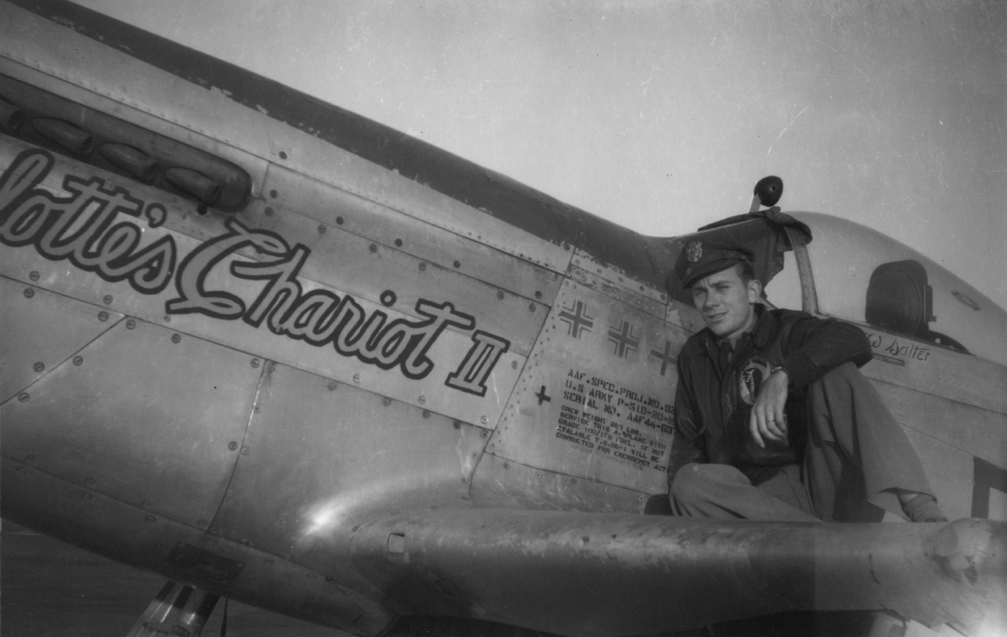 Lieutenant Cary Salter, a pilot of the 354th Fighter Group with his P-51 Mustang (FT-π), serial number 44-63747) nicknamed "Charlotte's Chariot II". (Photo USAAF via Cary Salter)
